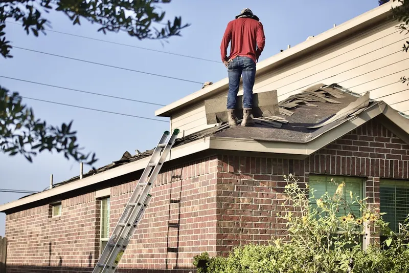 Professional roofer working on a residential roof in New Albany